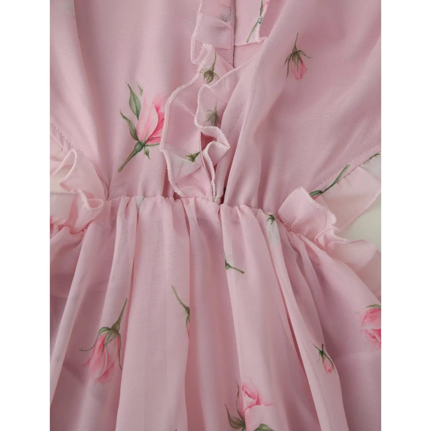 Side waist cutout close-up, elastic shirred waist panel surrounded by matching ruffle trim