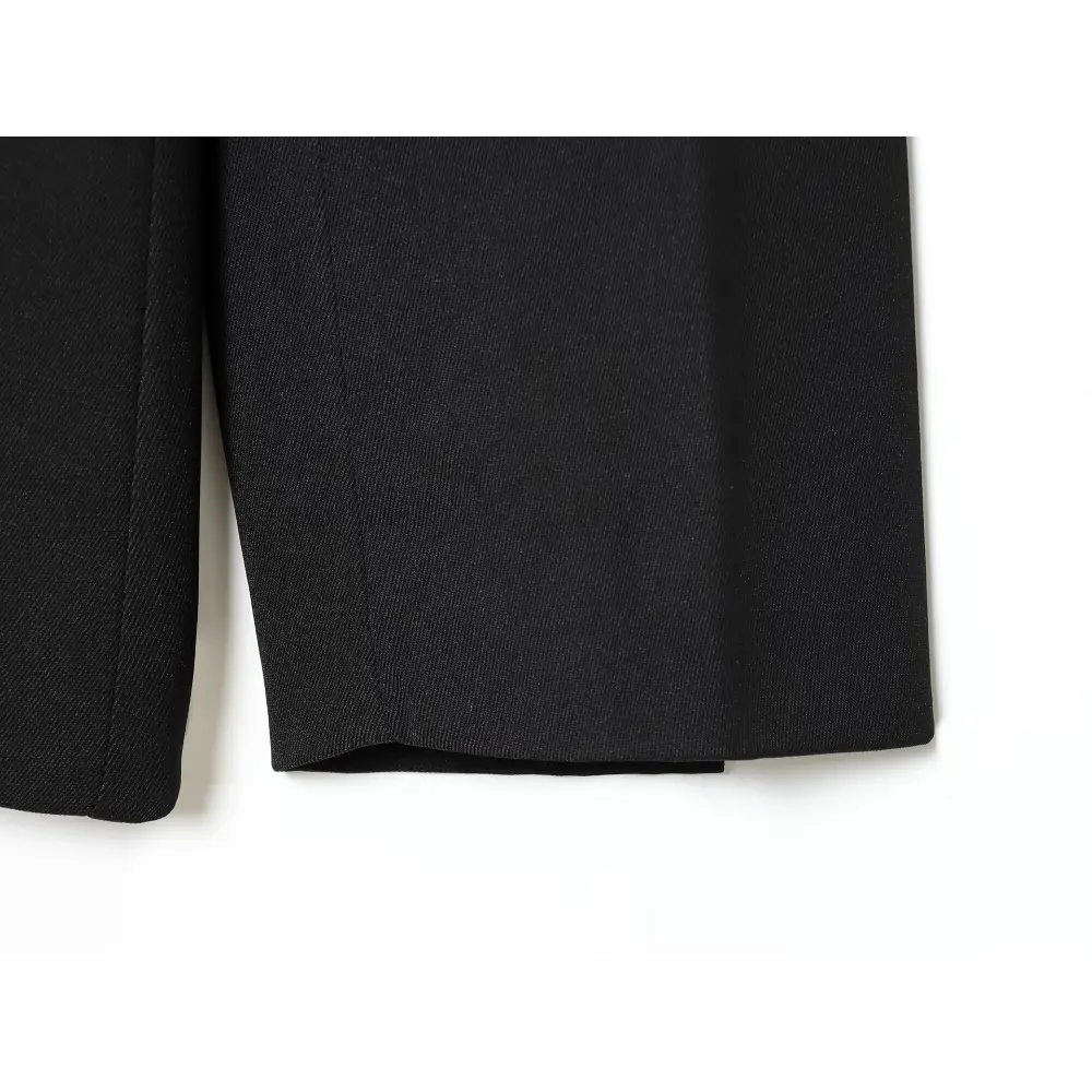 Close-up of black tailored trousers hem