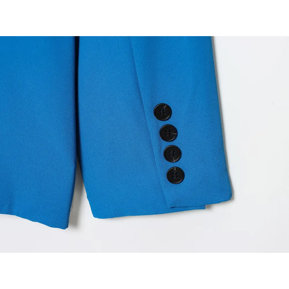 Close-up of blue sleeve cuff with four buttons