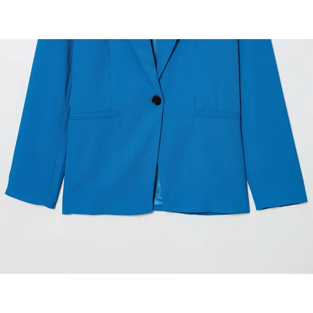 Close-up of blue blazer front, button and welt pockets