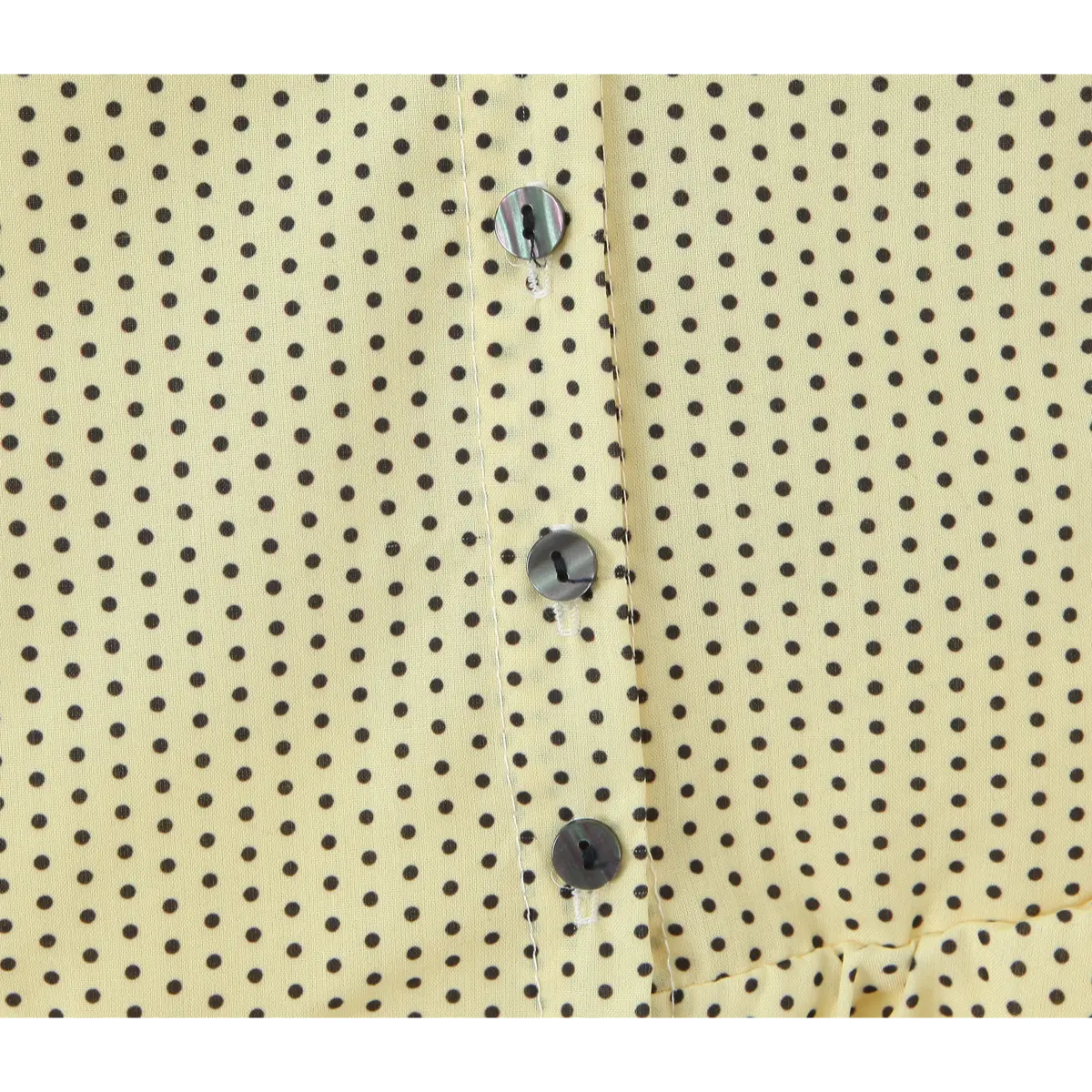 Single dark decor button & dot fabric close shot