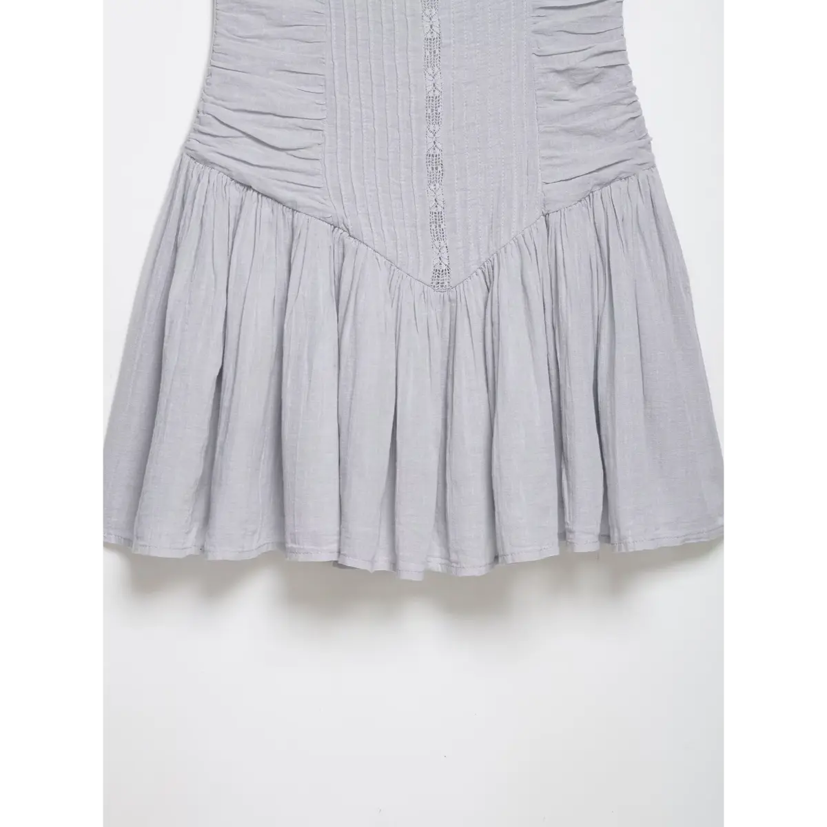 Close-up of the skirt and bodice on a gray lace cami dress, showing the gathered skirt and central lace panel.