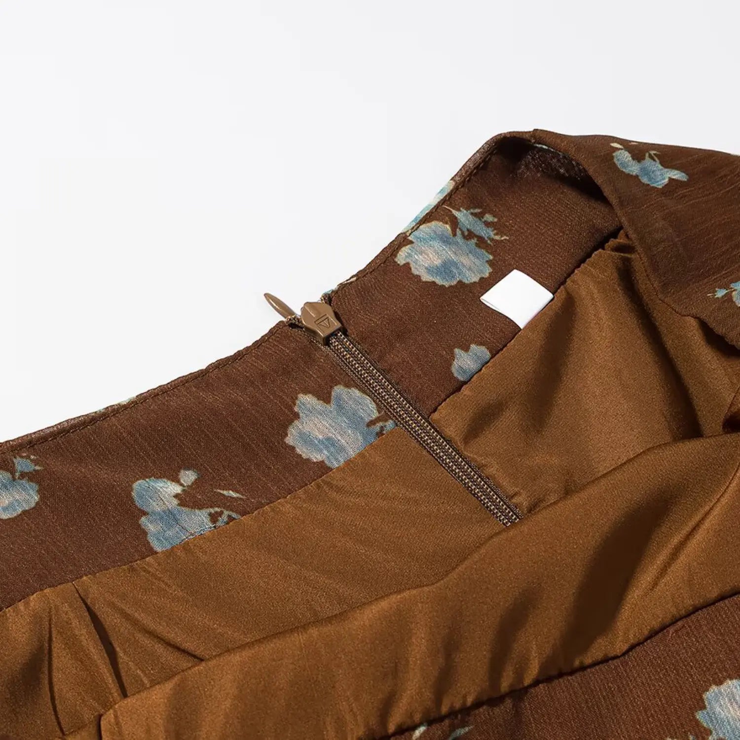 1. Skirt back waist zipper macro shot, matching brown fabric tape, metal zipper slider, inner size label