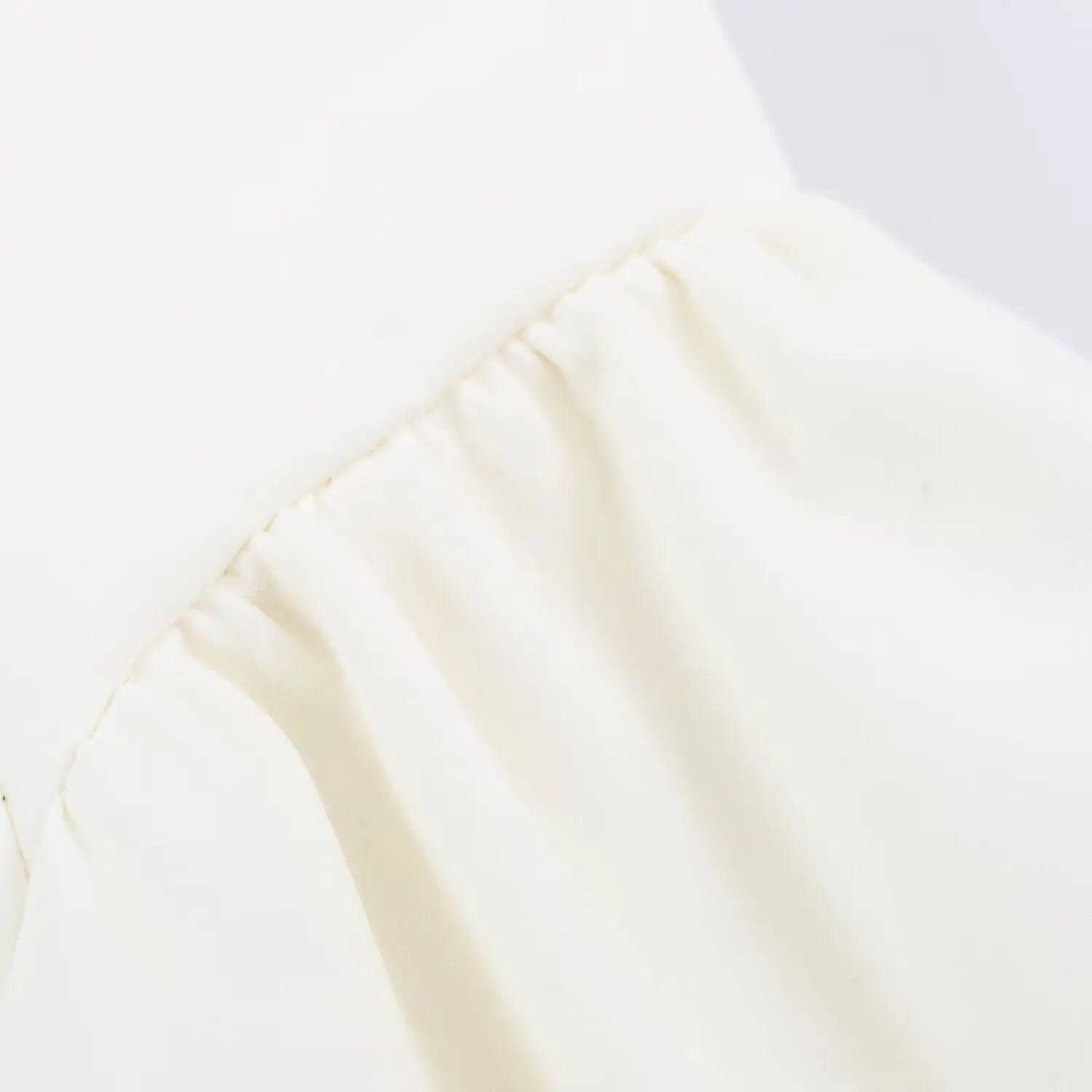 Close-up view of waist gathered seam for flare skirt panel