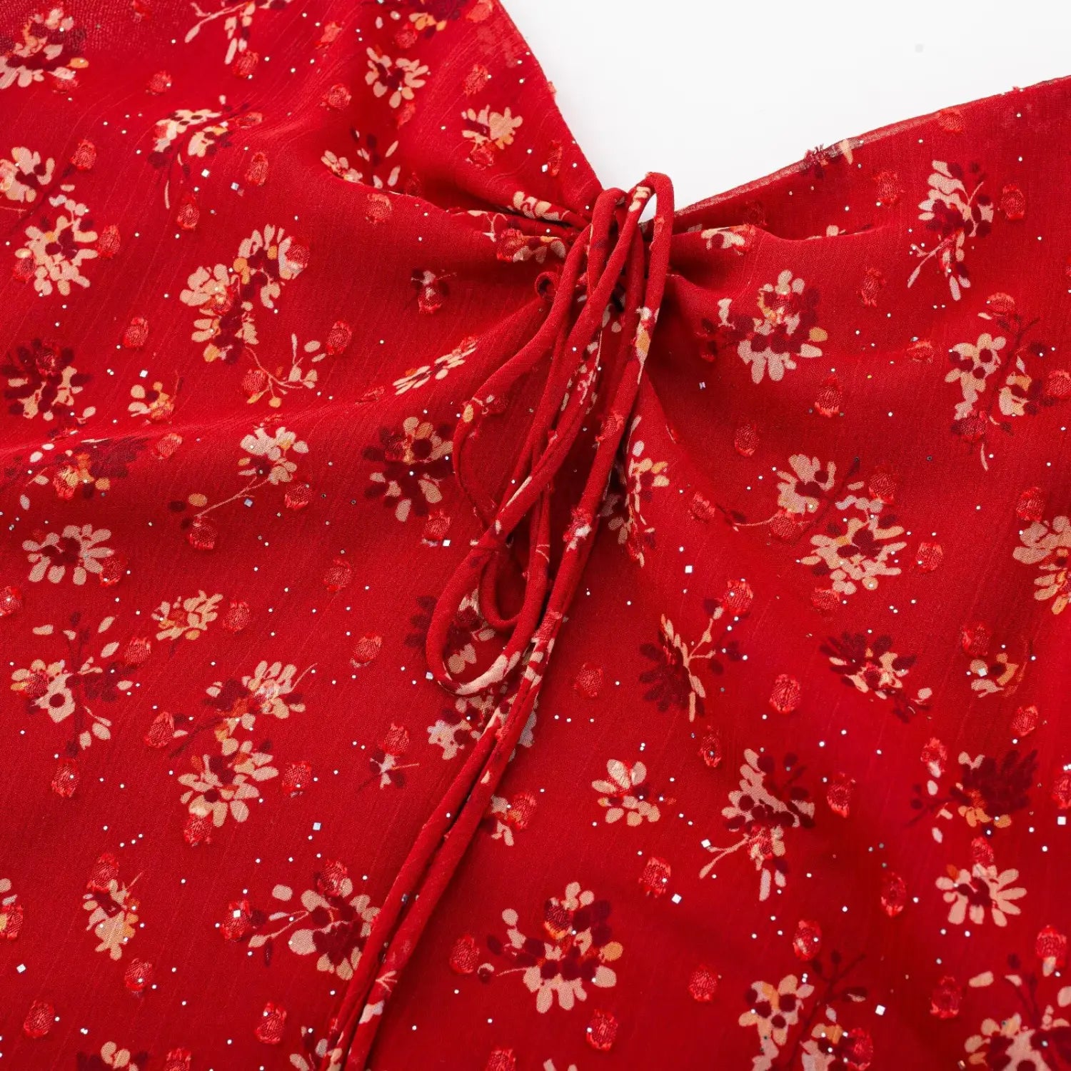 A-line skirt hem floral ruffle texture macro close-up, all over red floral with tiny sparkle lightweight chiffon natural drape soft hem detail shot