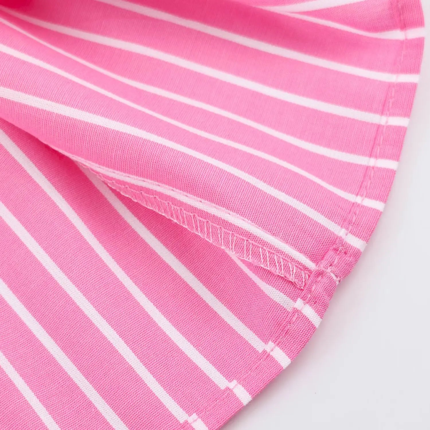 Extreme closeup finished hem stitching lightweight woven stripe fabric