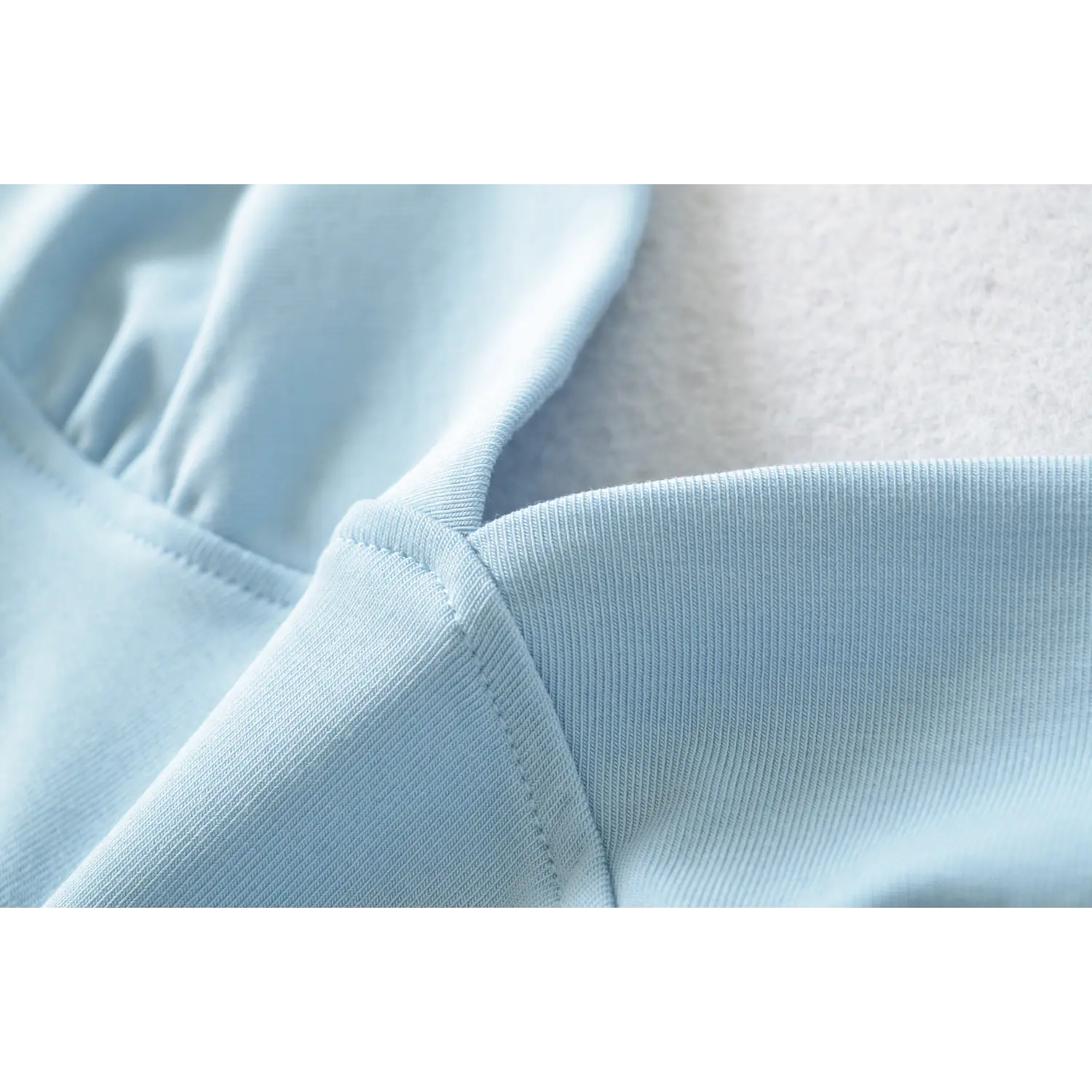 Macro detail light blue ribbed tank top front bust, gathered V neck stitching, neat folded seam workmanship stretch knit material