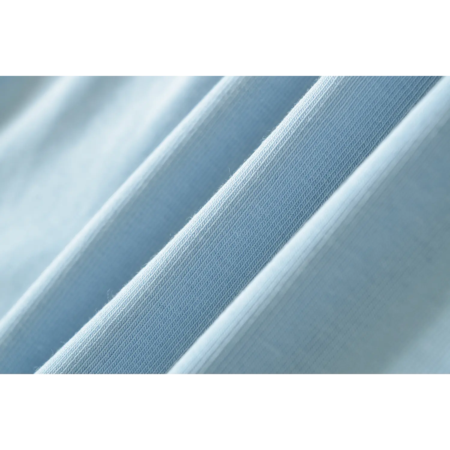 Extreme closeup fabric texture shot light blue premium vertical rib knit, soft stretch woven fine rib surface breathable material