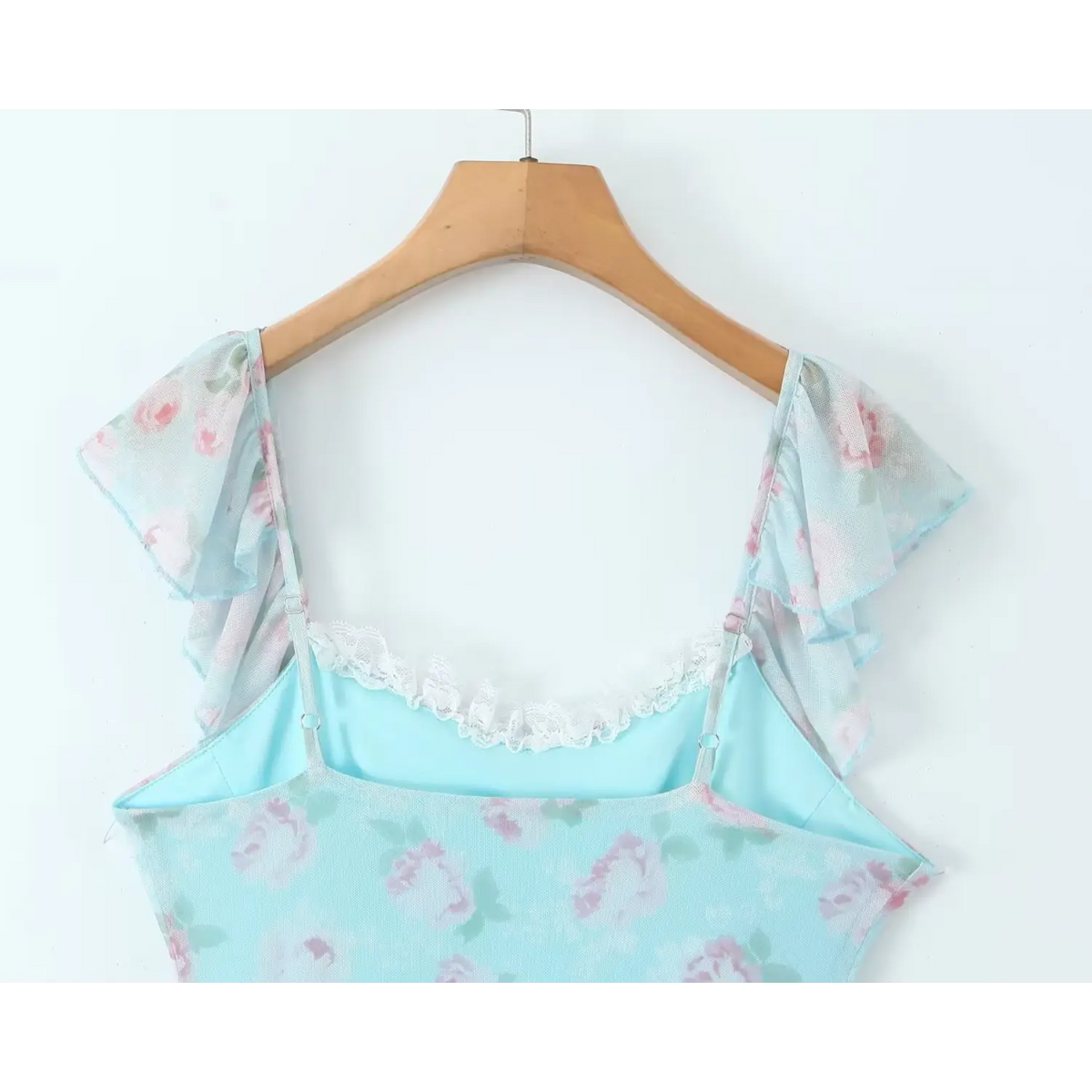 Hanger view of skyblue floral dress back, adjustable straps and lace trim inner neckline