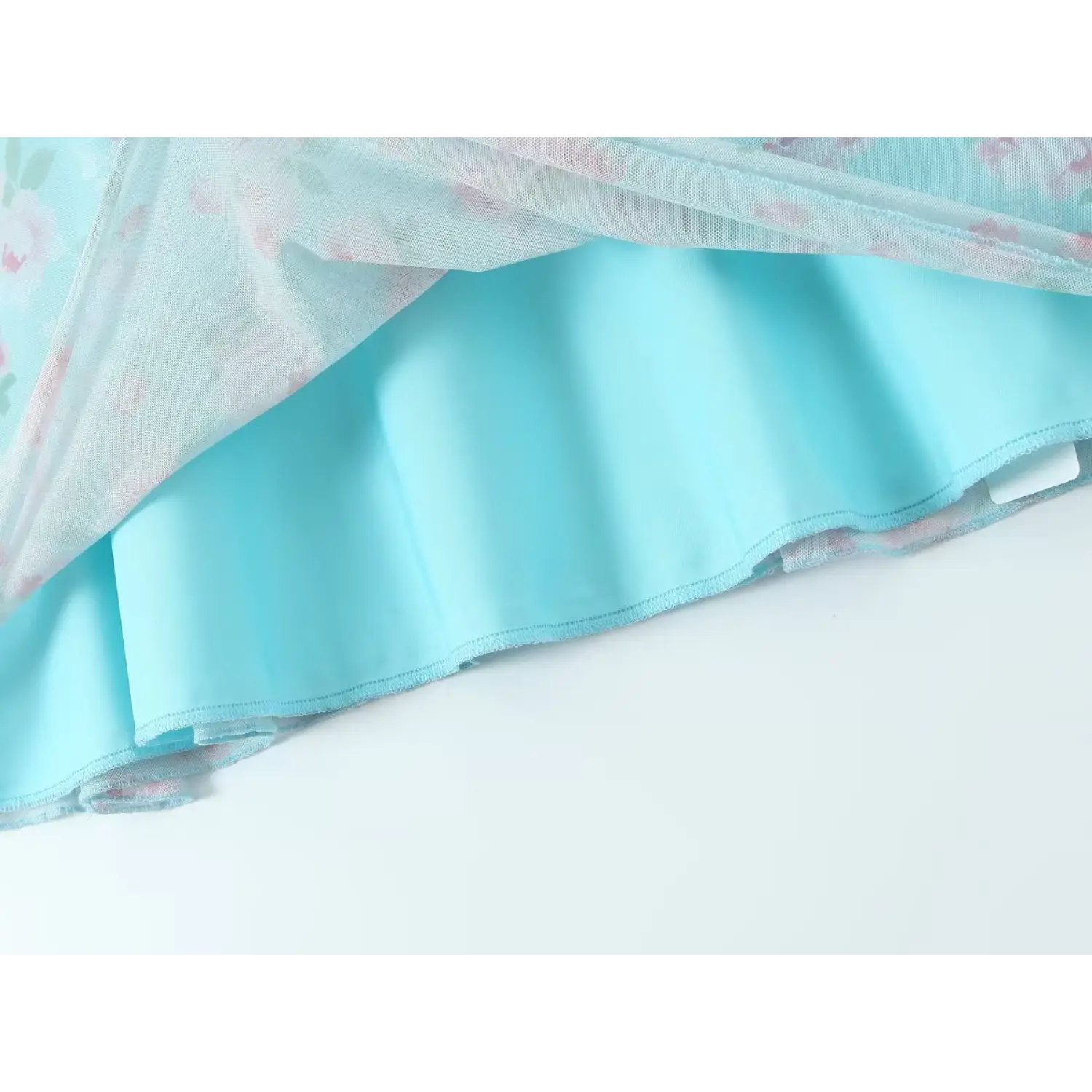 Detail shot showing mesh overlay and solid skyblue inner lining of floral mini dress