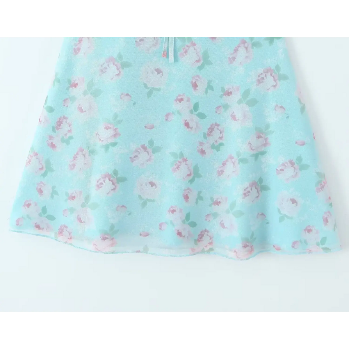 Close‑up of flared skirt hem with rose floral print on skyblue mesh mini dress