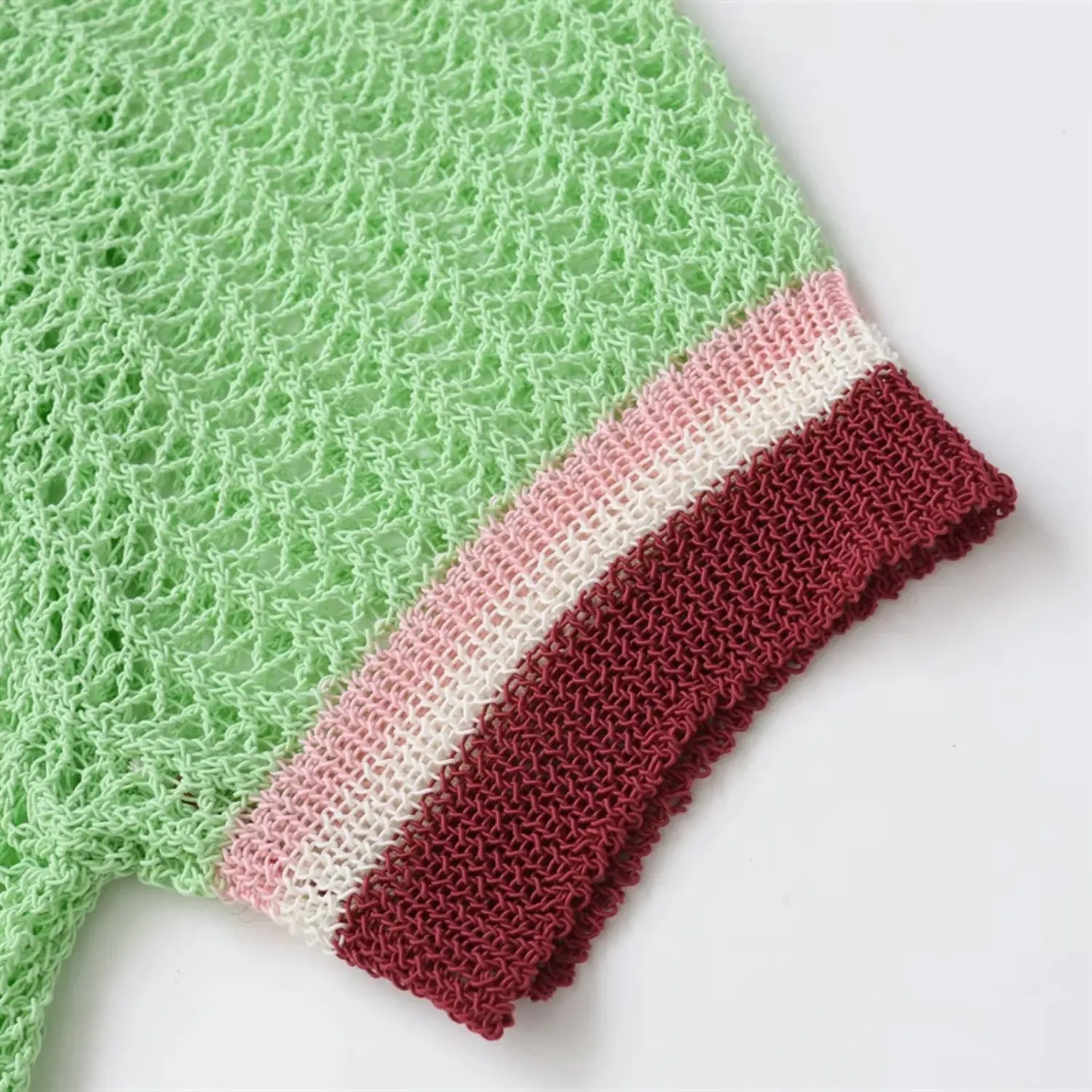 Short sleeve cuff close-up, horizontal pink, white and burgundy ribbed trim, stretchy knit edge, neat folded finish