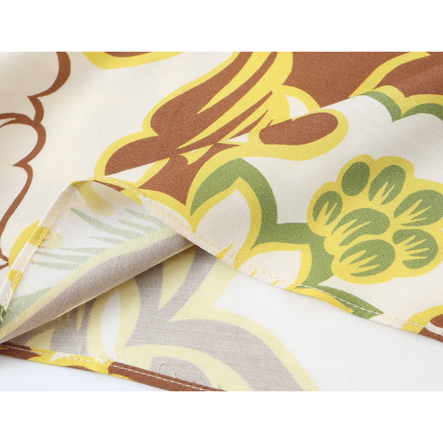 Folded fabric macro view showing weave and hem stitching of retro floral midi cami dress