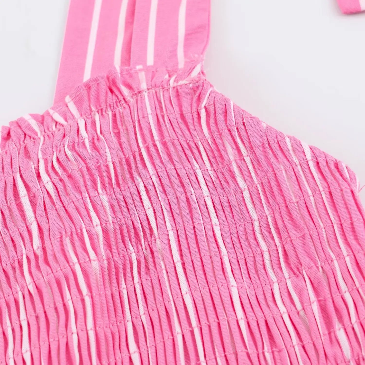 Closeup stretch smocked stitching and frill trim on bust panel