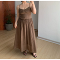Casual front indoor mirror full shot of mocha brown textured cami maxi dress, ruched sweetheart bust, ruffled empire waist, voluminous gathered flowy long skirt, thin adjustable spaghetti straps, lightweight soft matte fabric, black thin strap slide sandals, minimalist neutral room decor