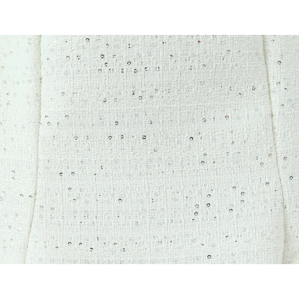 Macro fabric view, coarse tweed weave evenly dotted with tiny silver glitter sequins.