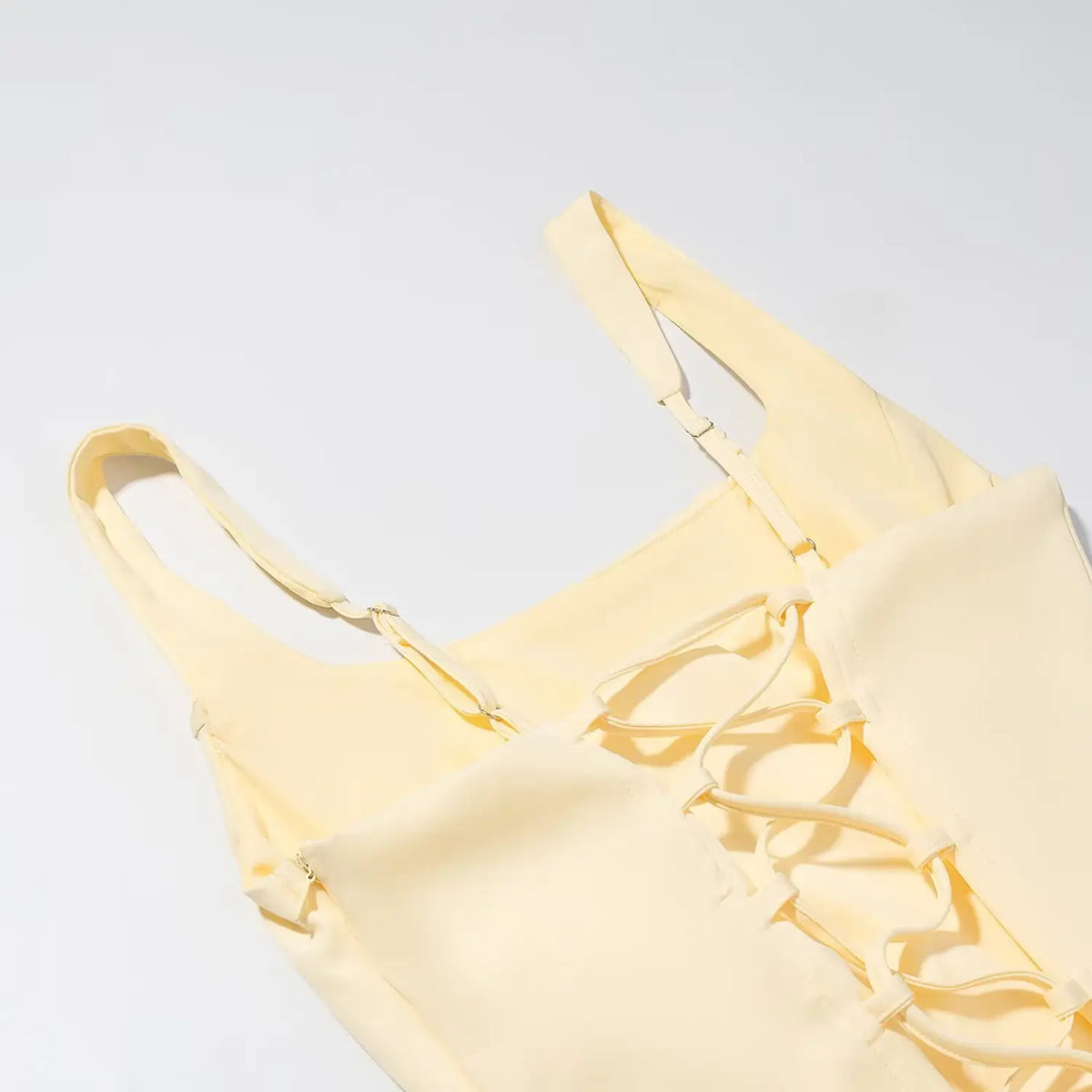 Close-up of lace up back and strap adjuster