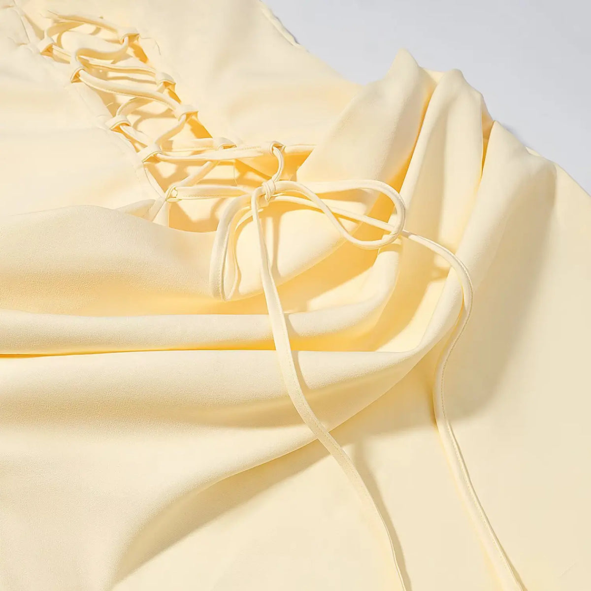 Close-up of lace up back bow and draped waist