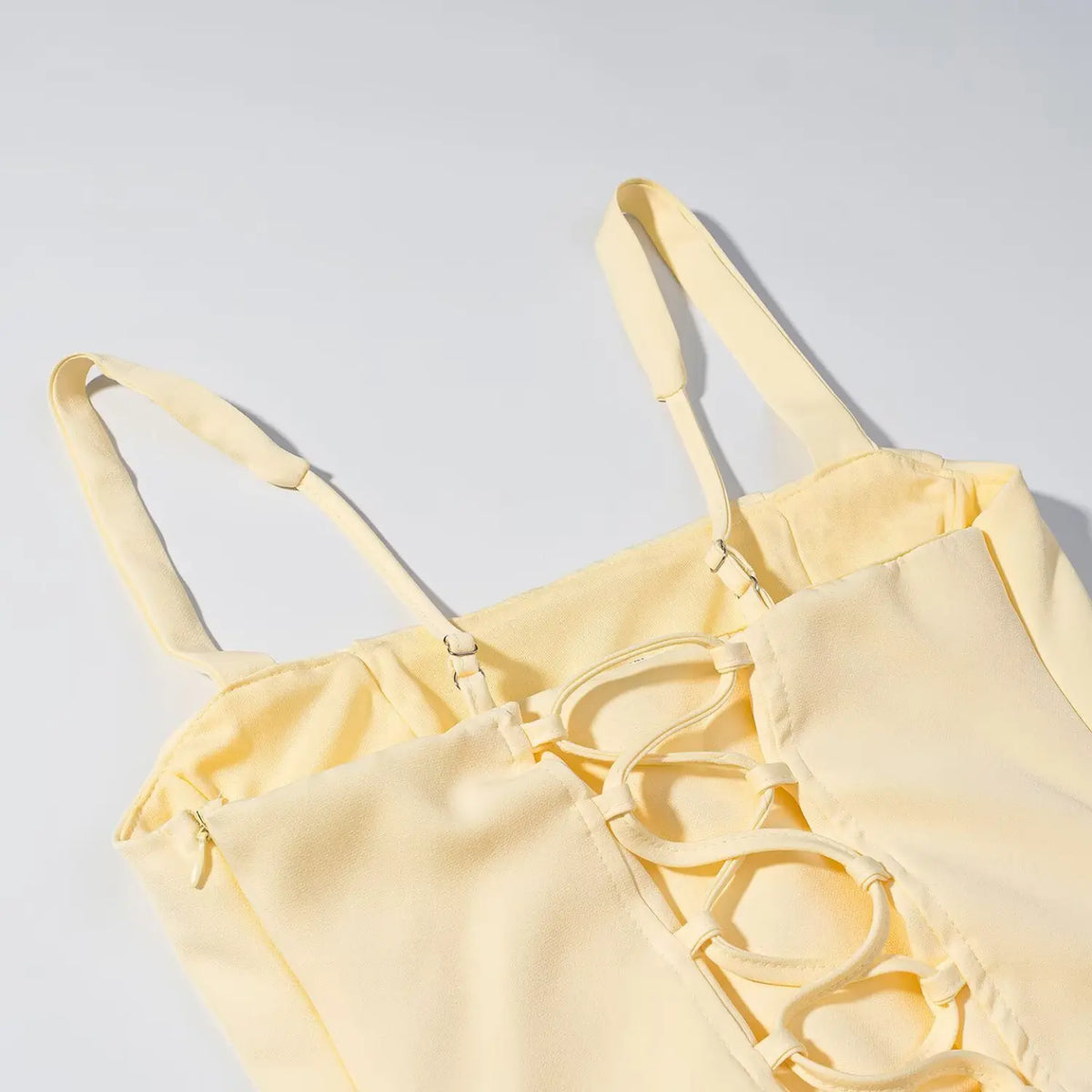 Close-up of lace up back and strap adjuster