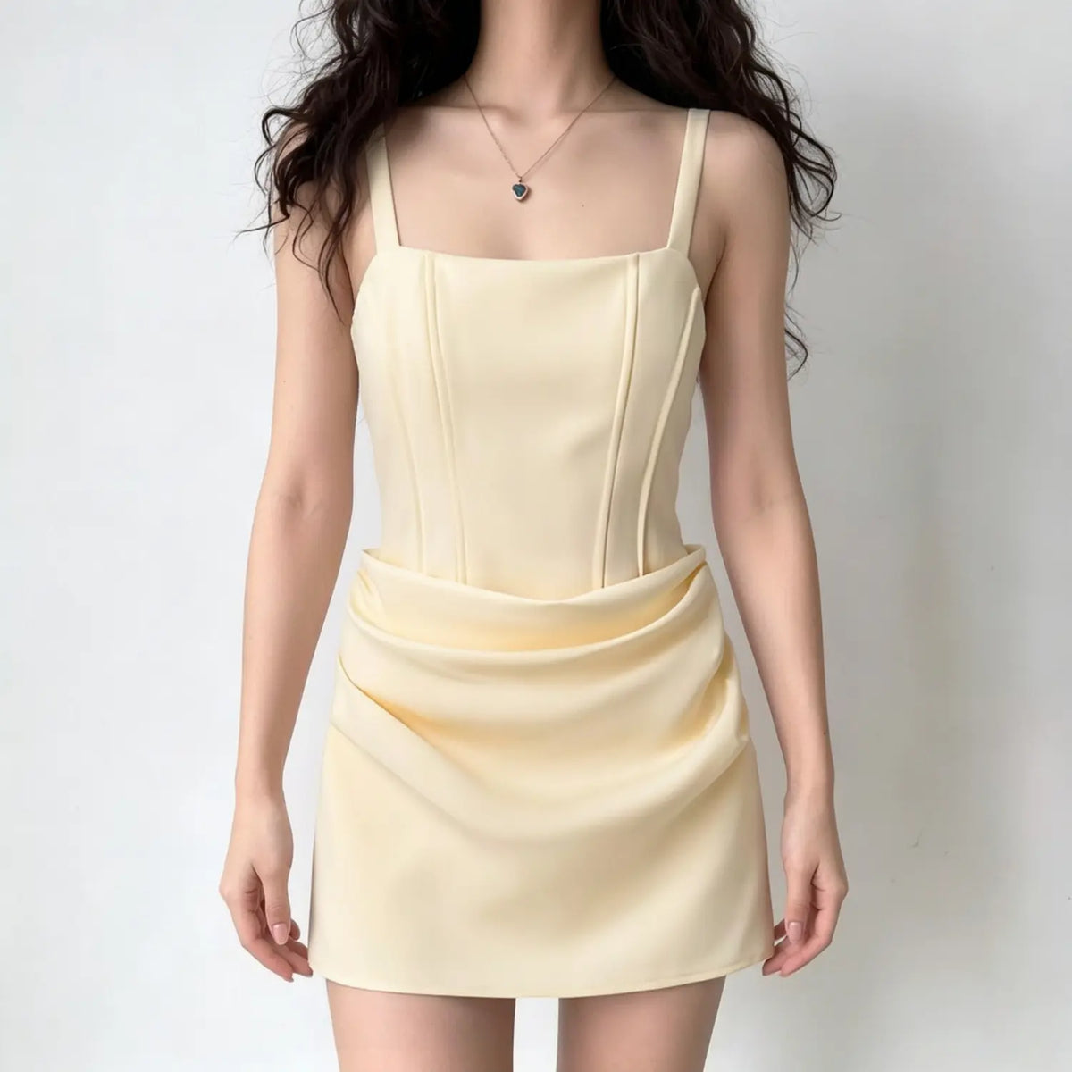 Model wearing square neck corset lace up draped mini dress