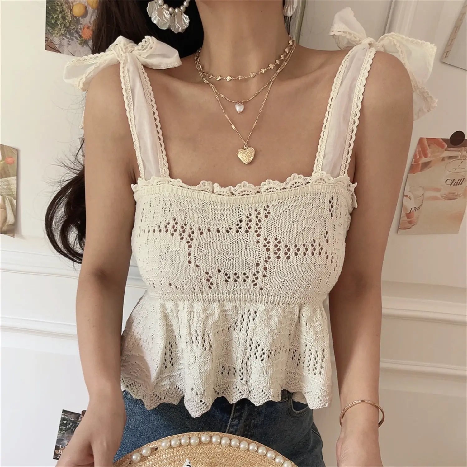 Full front view white crochet knit camisole, lace edged straps, self-tie shoulder bows, elastic peplum hem