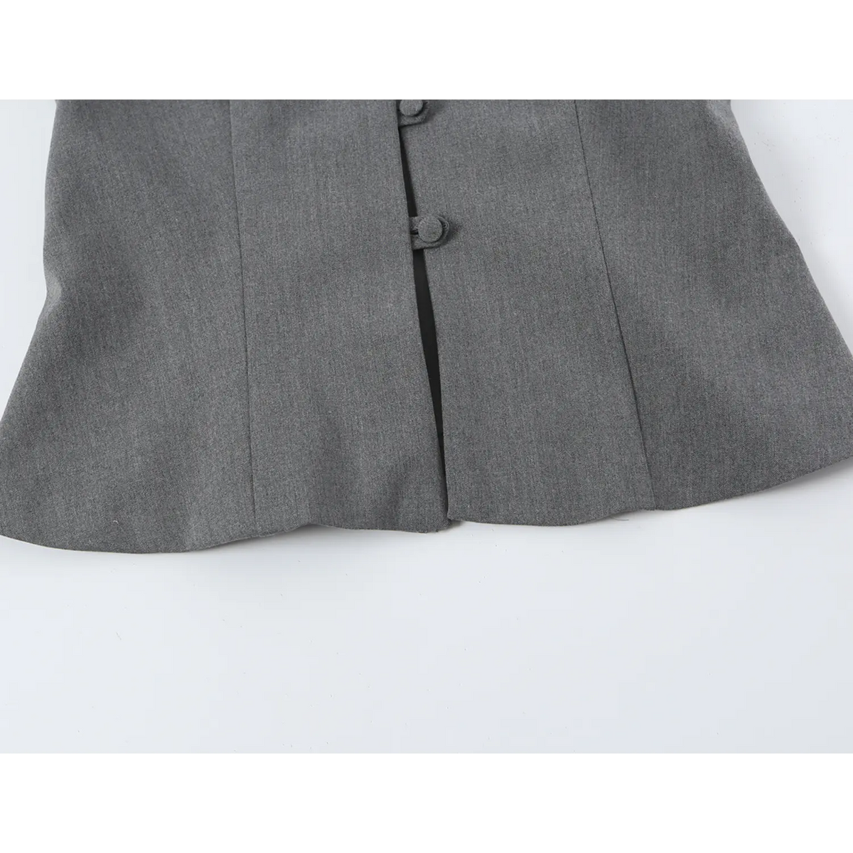 Close-up of cropped hem and front buttons