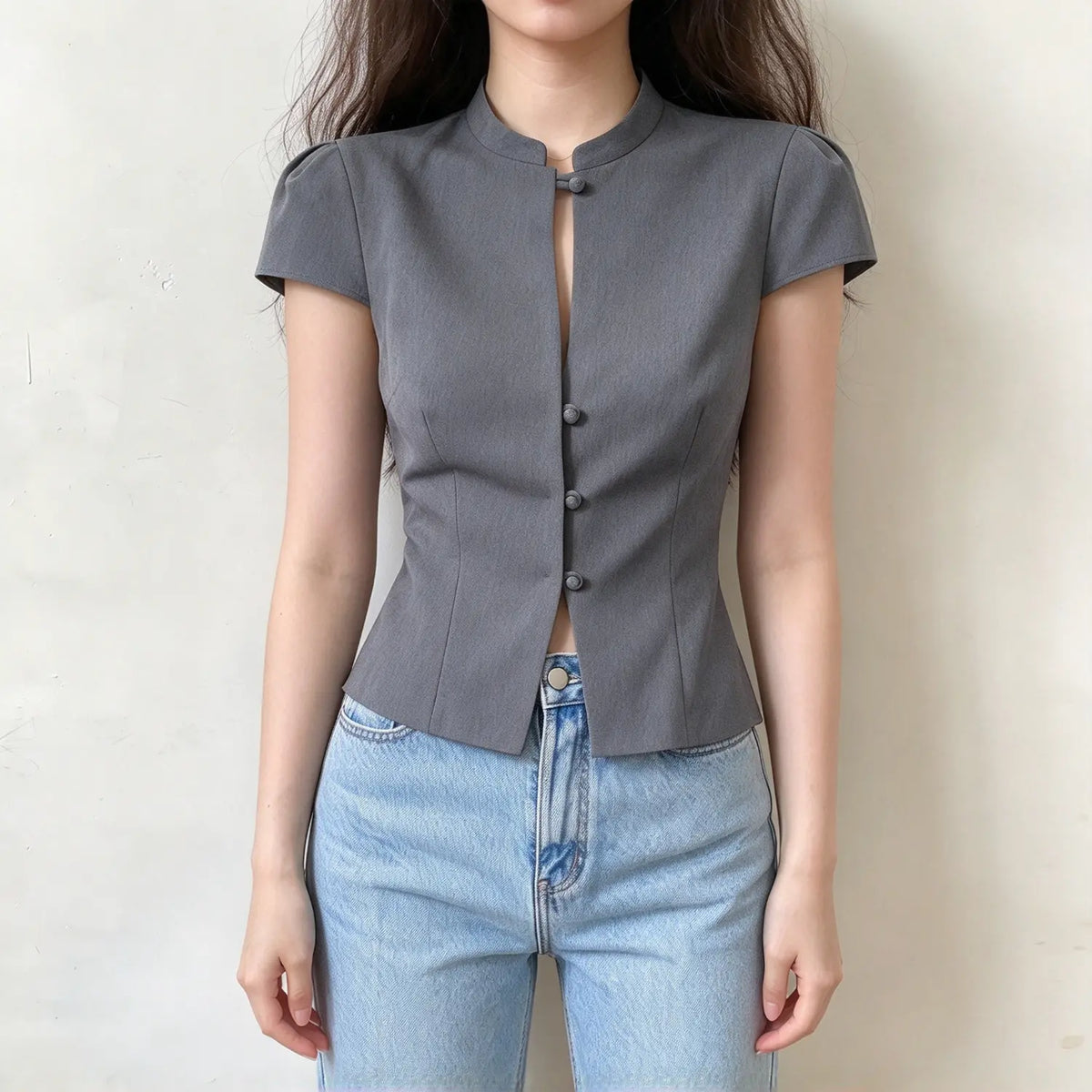 Model wearing gray stand collar covered button petal sleeve blouse, front view