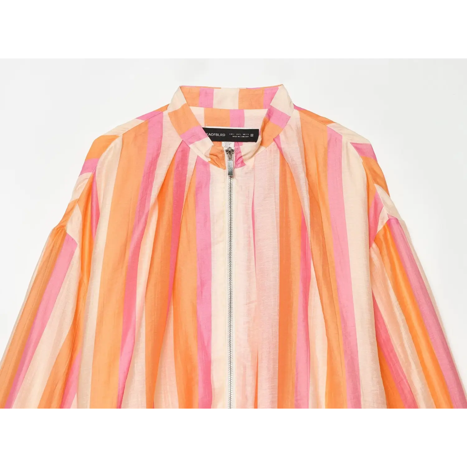 Neckline partial close-up, upright stand collar, center front metal zipper, striped lightweight woven fabric