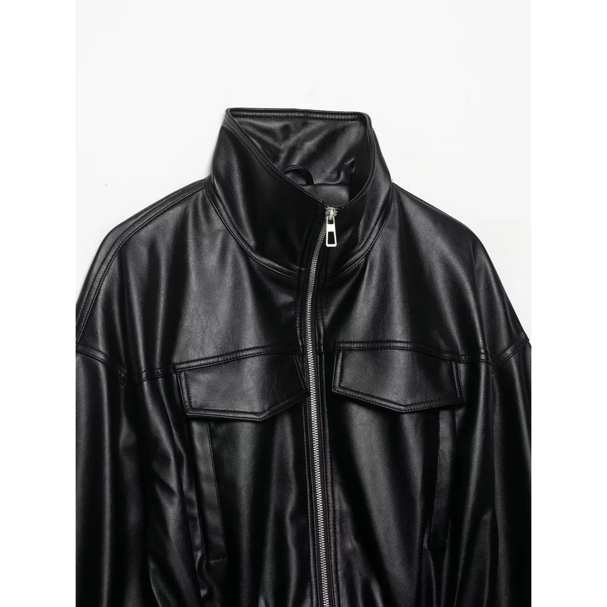 Close-up of black stand collar, zip and chest flap pockets
