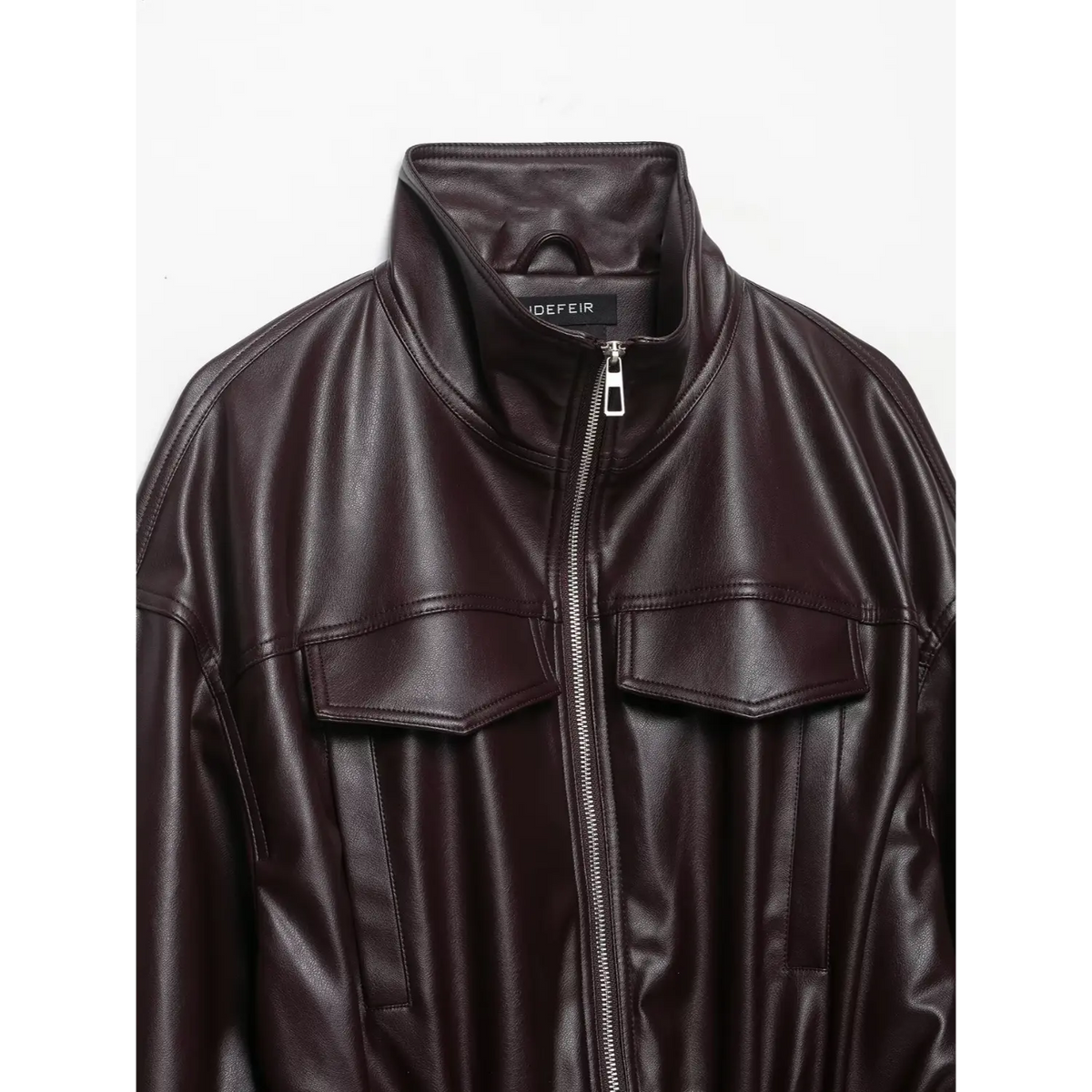 Close-up of burgundy stand collar, zip and chest flap pockets