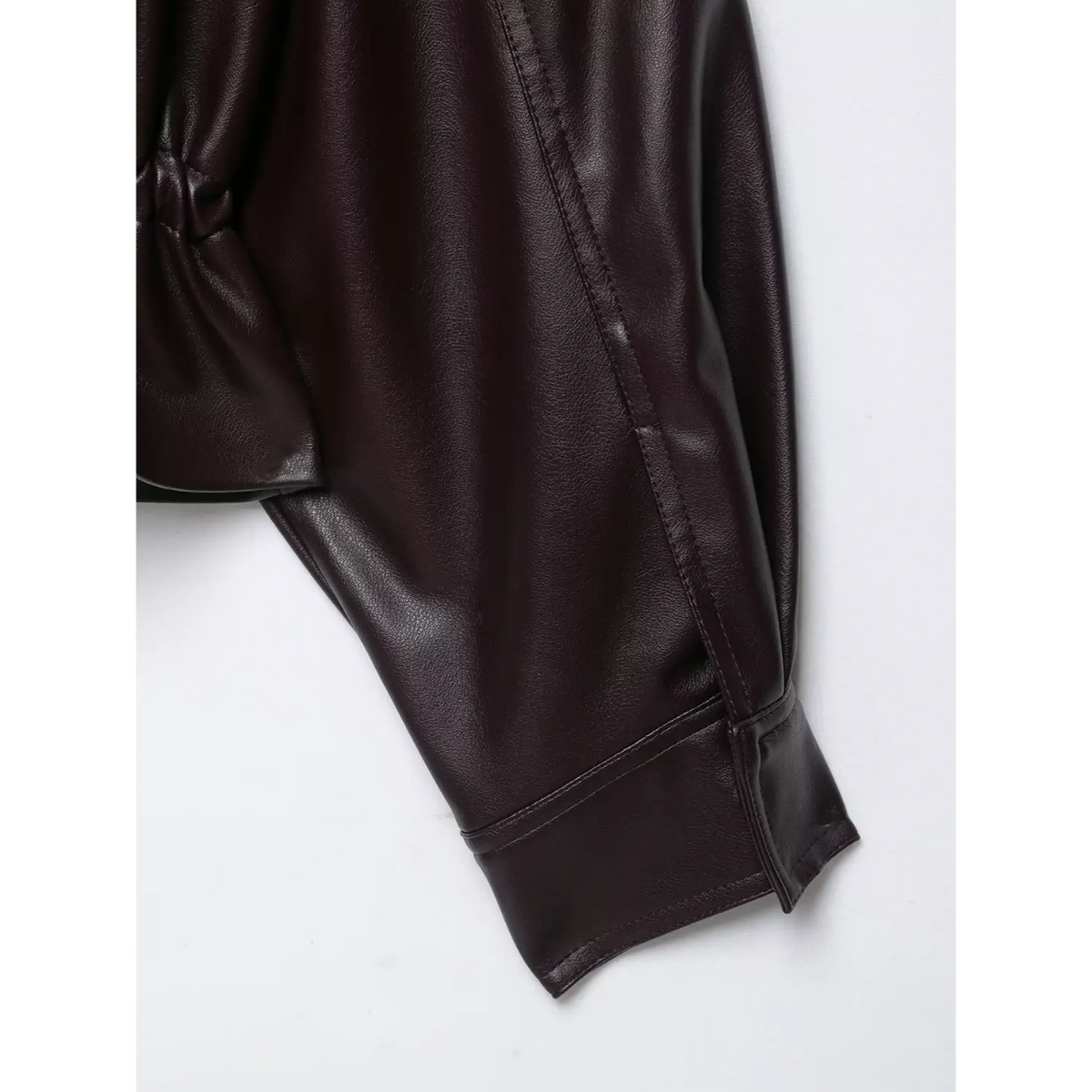 Close-up of burgundy cuff and shoulder stitching