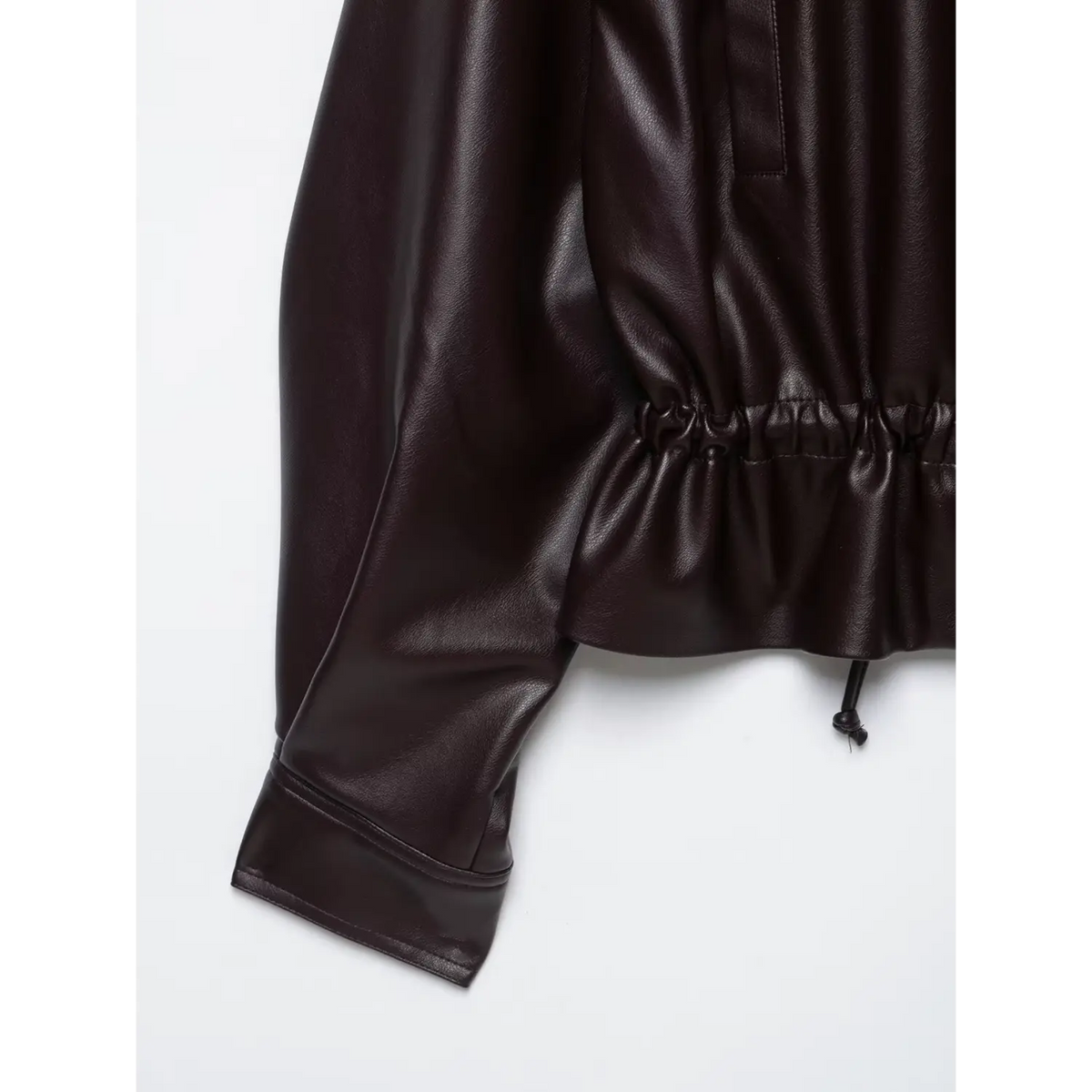 Close-up of burgundy elasticated hem, drawstring and cuff
