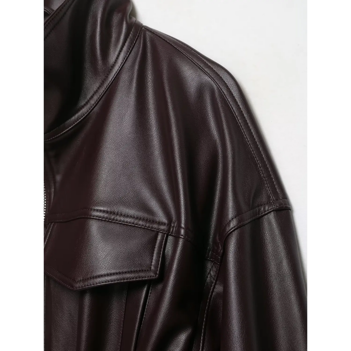 Close-up of burgundy shoulder stitching and chest flap pocket