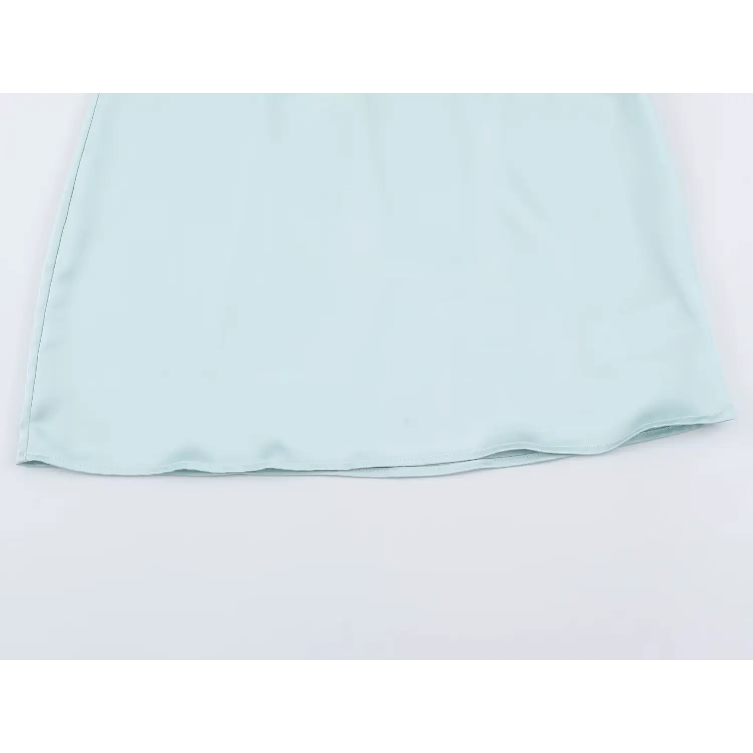 Smooth straight mini skirt hem of light blue satin dress