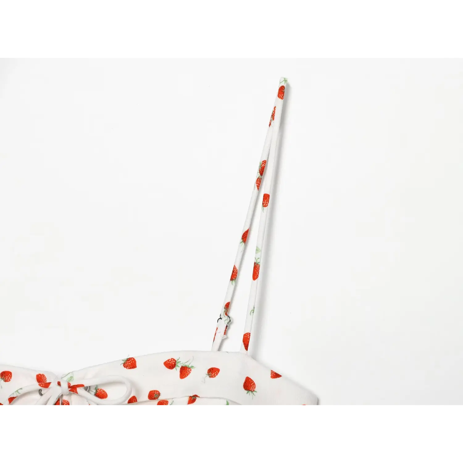 Close‑up detail of adjustable spaghetti strap with strawberry print fabric