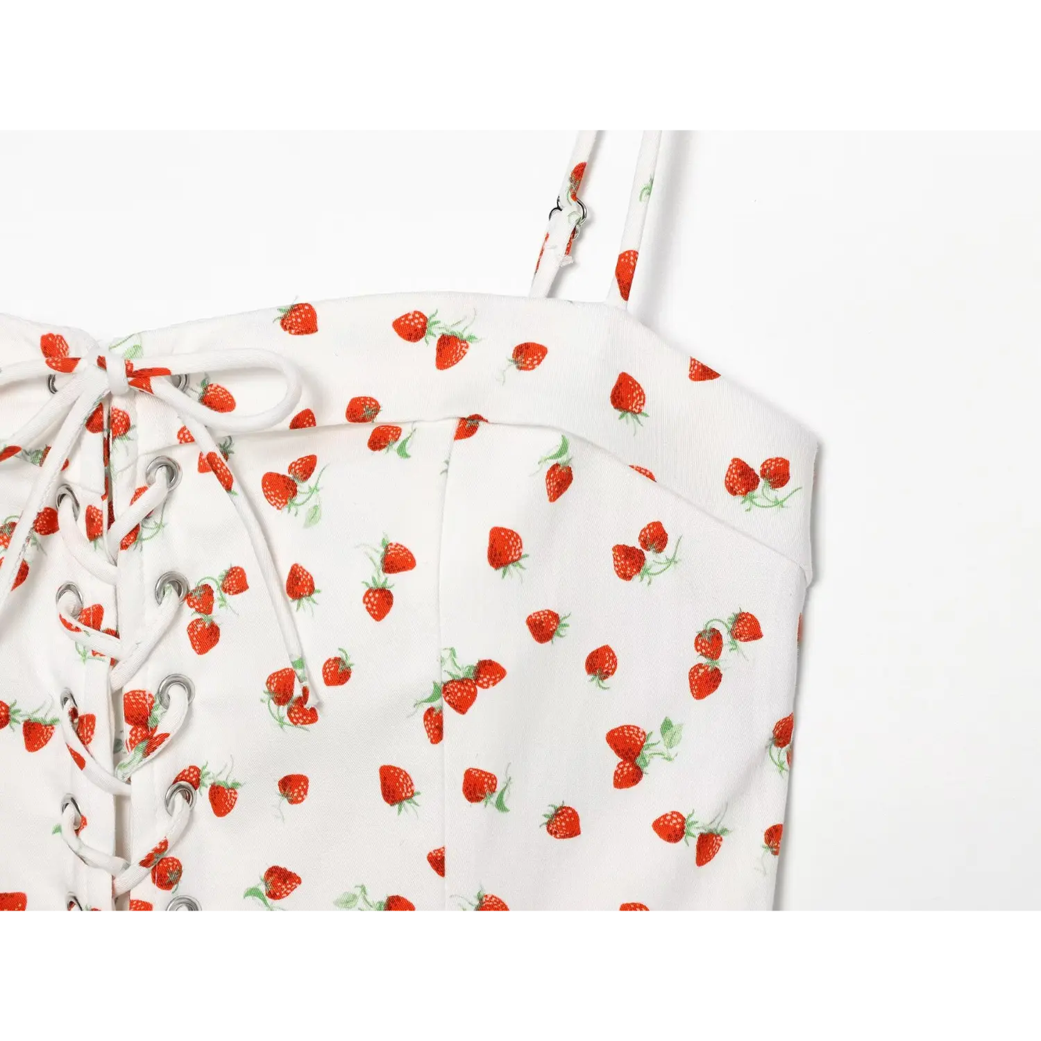 Close‑up of bust seam and strawberry print pattern on cami top