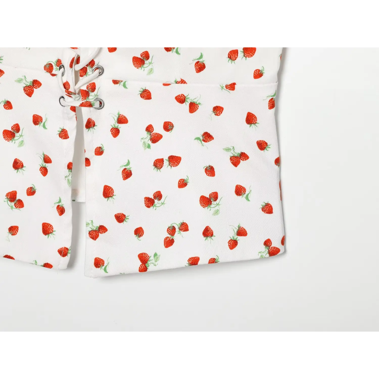 Close‑up of front split hem fabric with strawberry all‑over print