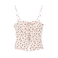 Flat lay front view white cami top with all‑over red strawberry print, lace‑up tie front and split hem