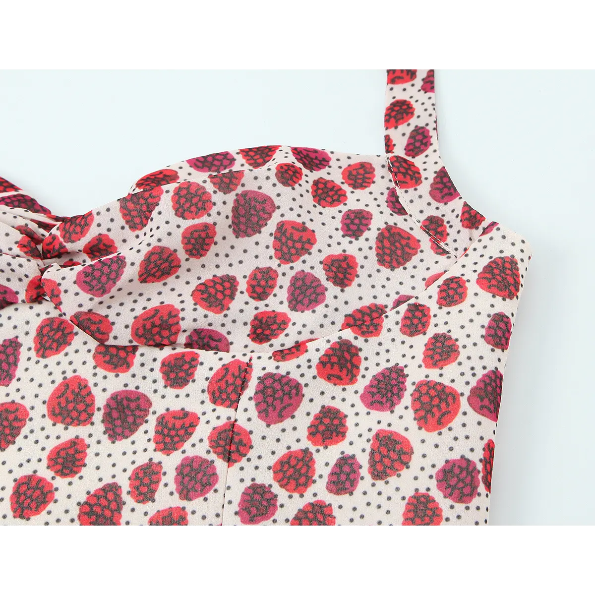 Close-up of the halter top bodice, showing the sweetheart neckline, gathered detail, and strawberry print