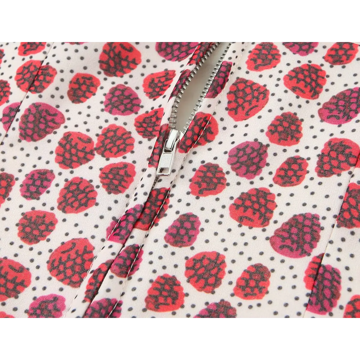Close-up of the side zipper on the strawberry print halter top, showing the metal pull and matching print fabric