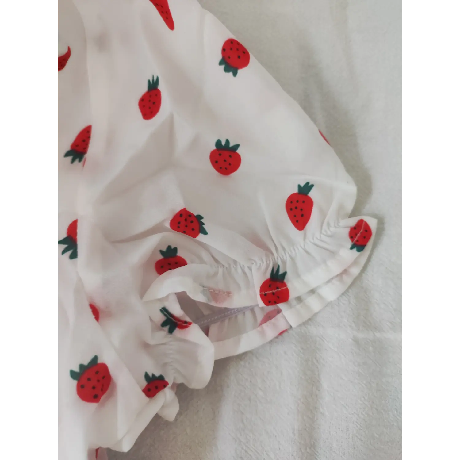Extreme close-up side invisible zipper and sleeve hem strawberry crop top