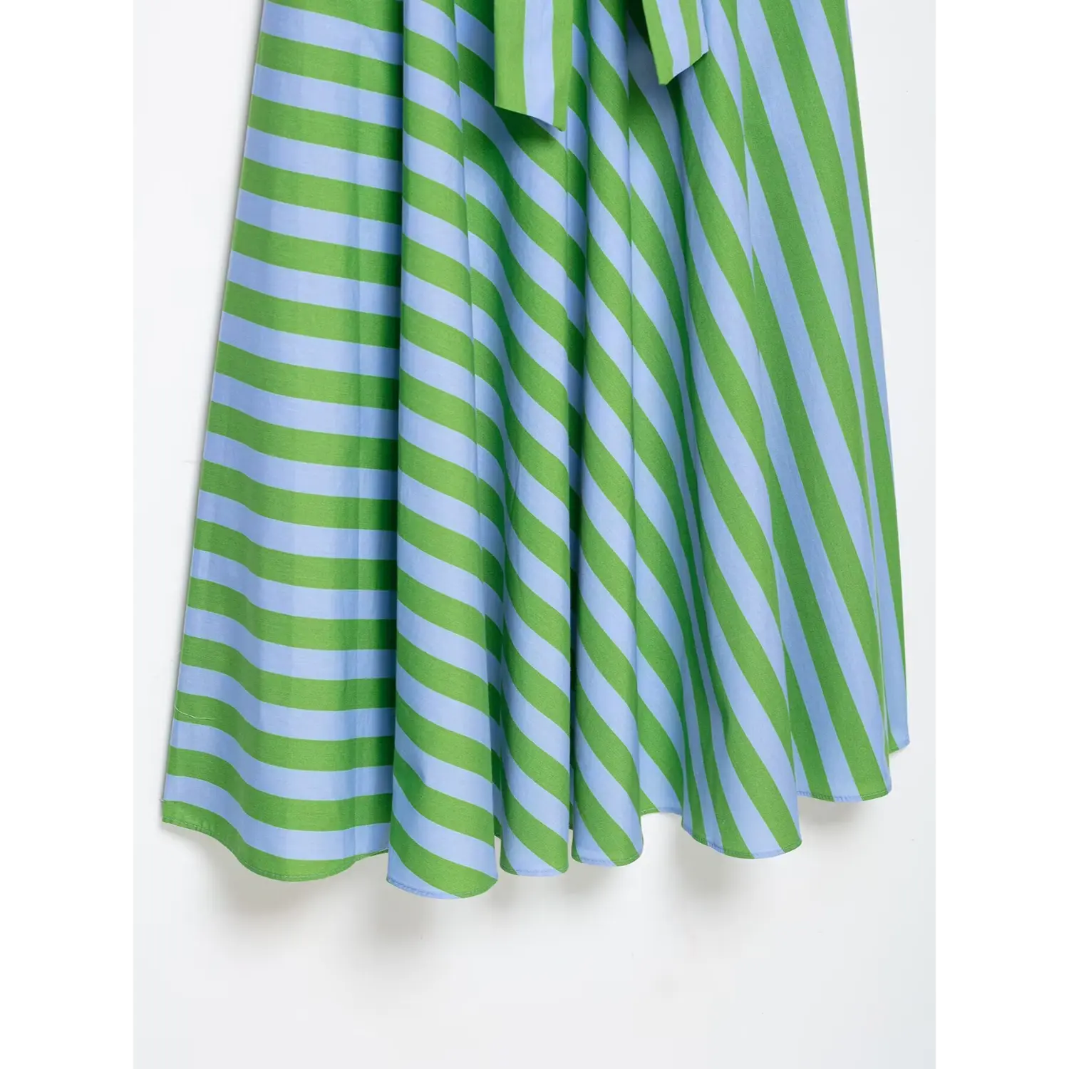 Close-up of flared skirt diagonal stripe fabric and pleat detail on green blue camisole midi dress