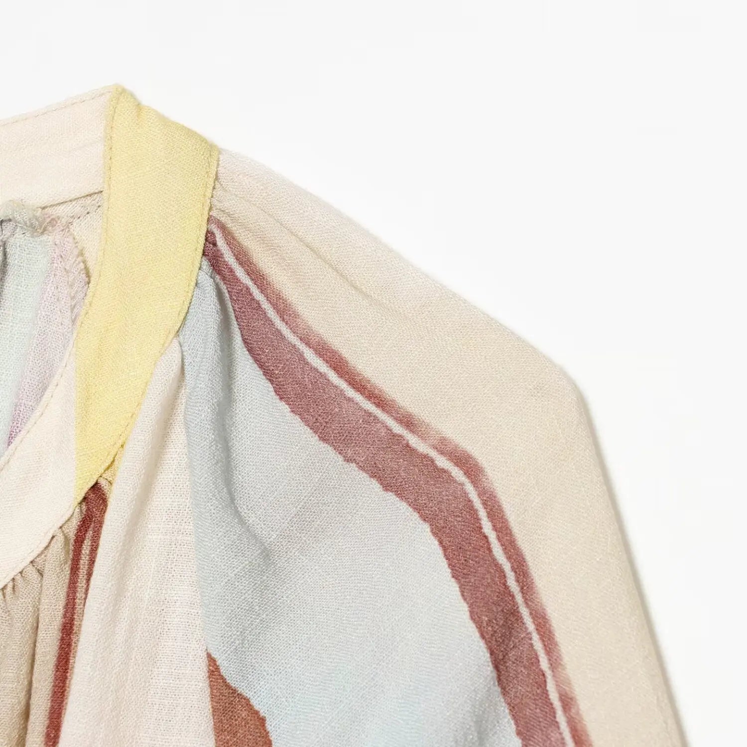 Macro shot of striped midi dress collar, shoulder seam and textured woven fabric detail
