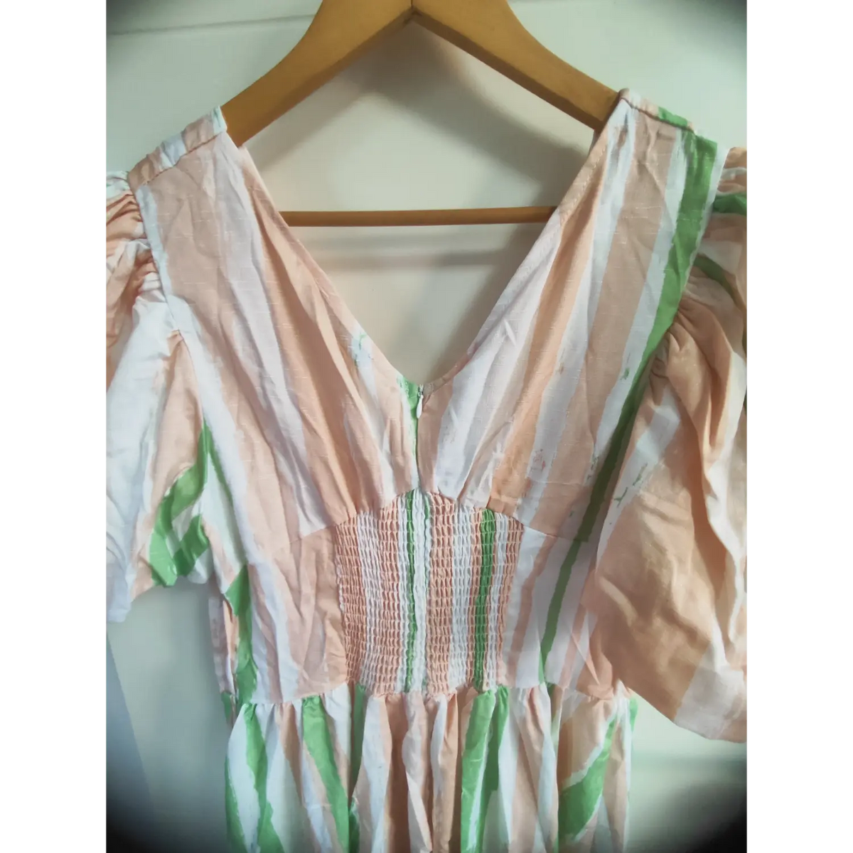 Close up of puff short sleeve detail on pink green white brushstroke striped maxi dress
