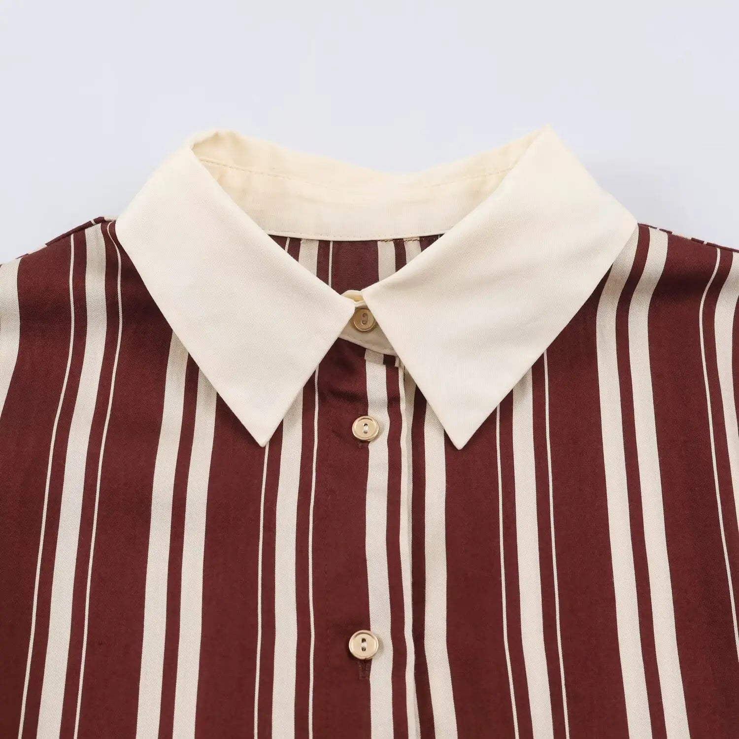 Close‑up view of shirt collar and gold front buttons on burgundy white stripe maxi dress