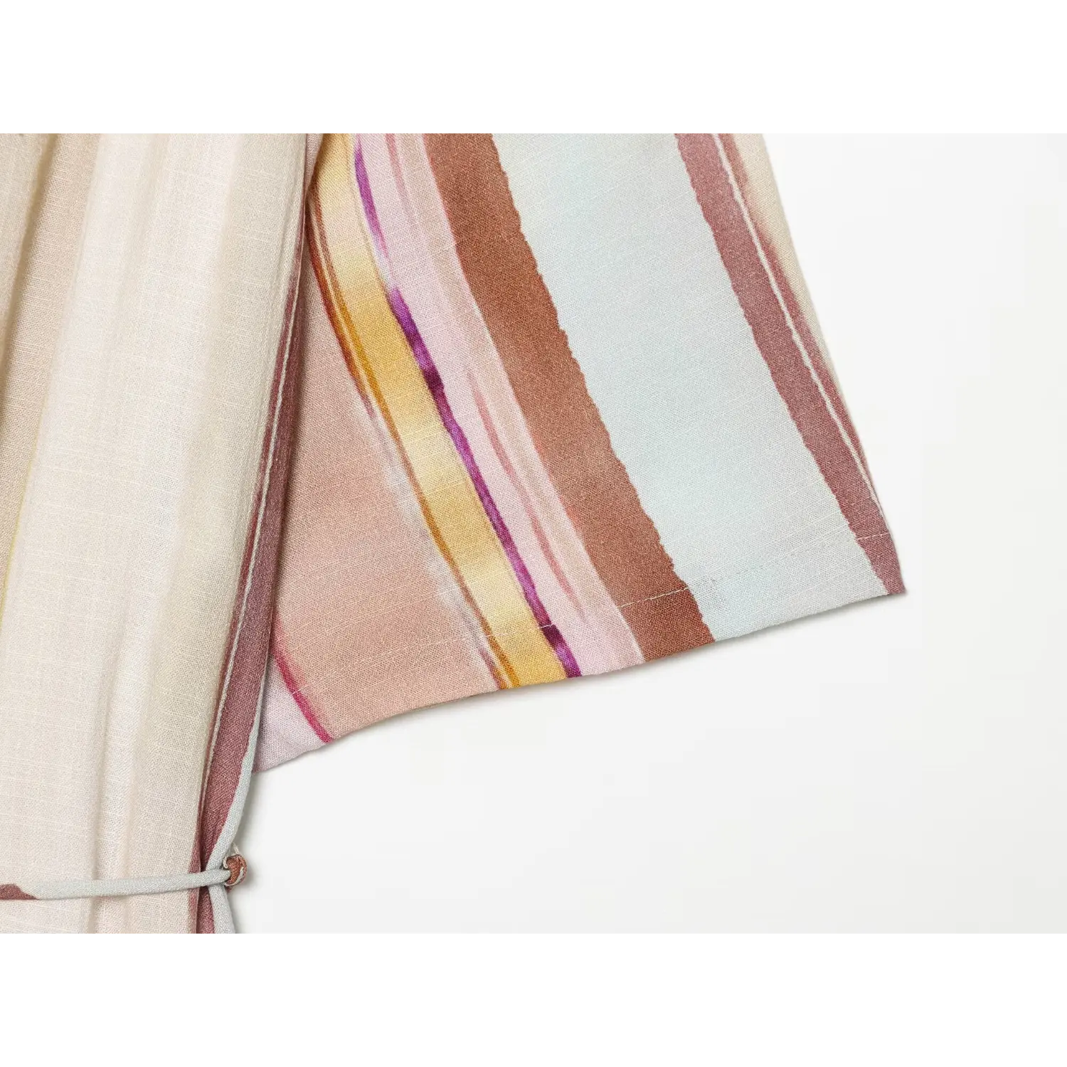 Close‑up of short kimono sleeve hem and multi‑color vertical stripe fabric texture