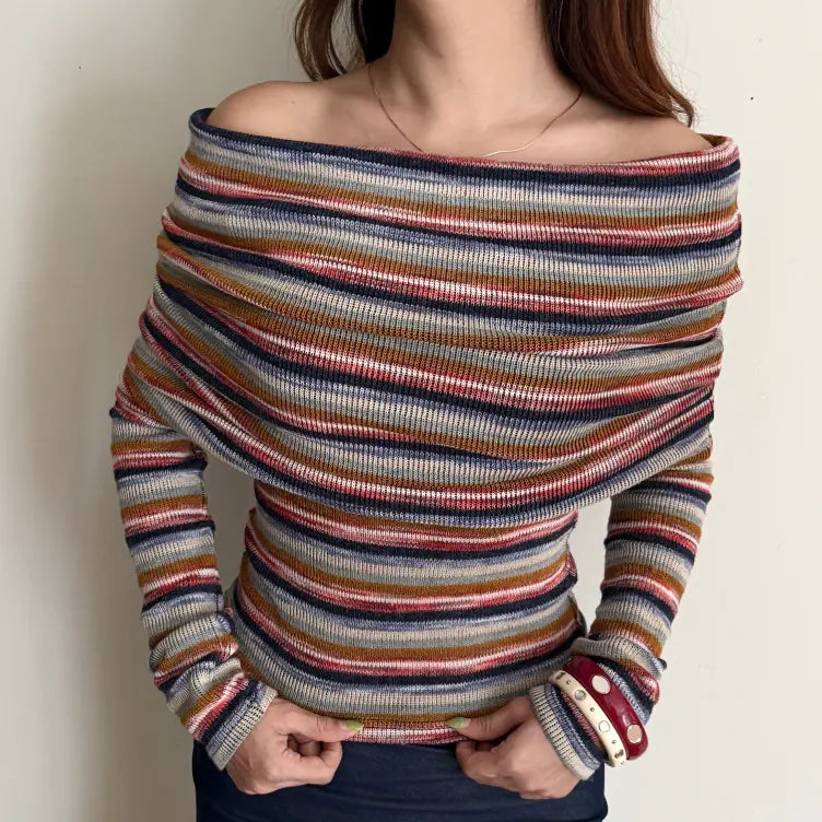 Model wearing stripe off shoulder cowl neck fitted knit top, hands at hem view