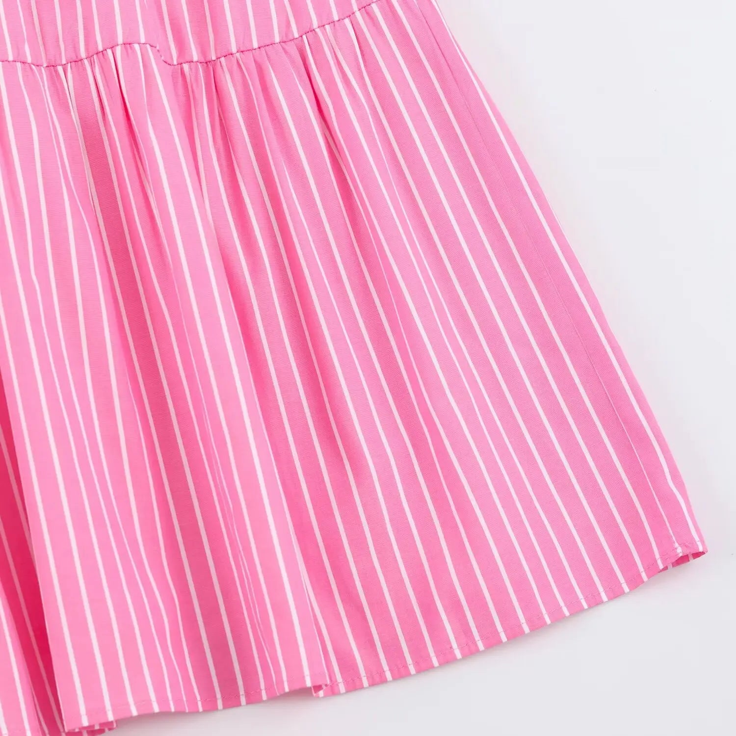 Closeup vertical stripe fabric drape on flowy skirt panel