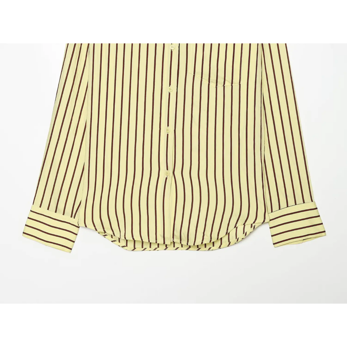 Close-up of curved hem and wide striped cuffs
