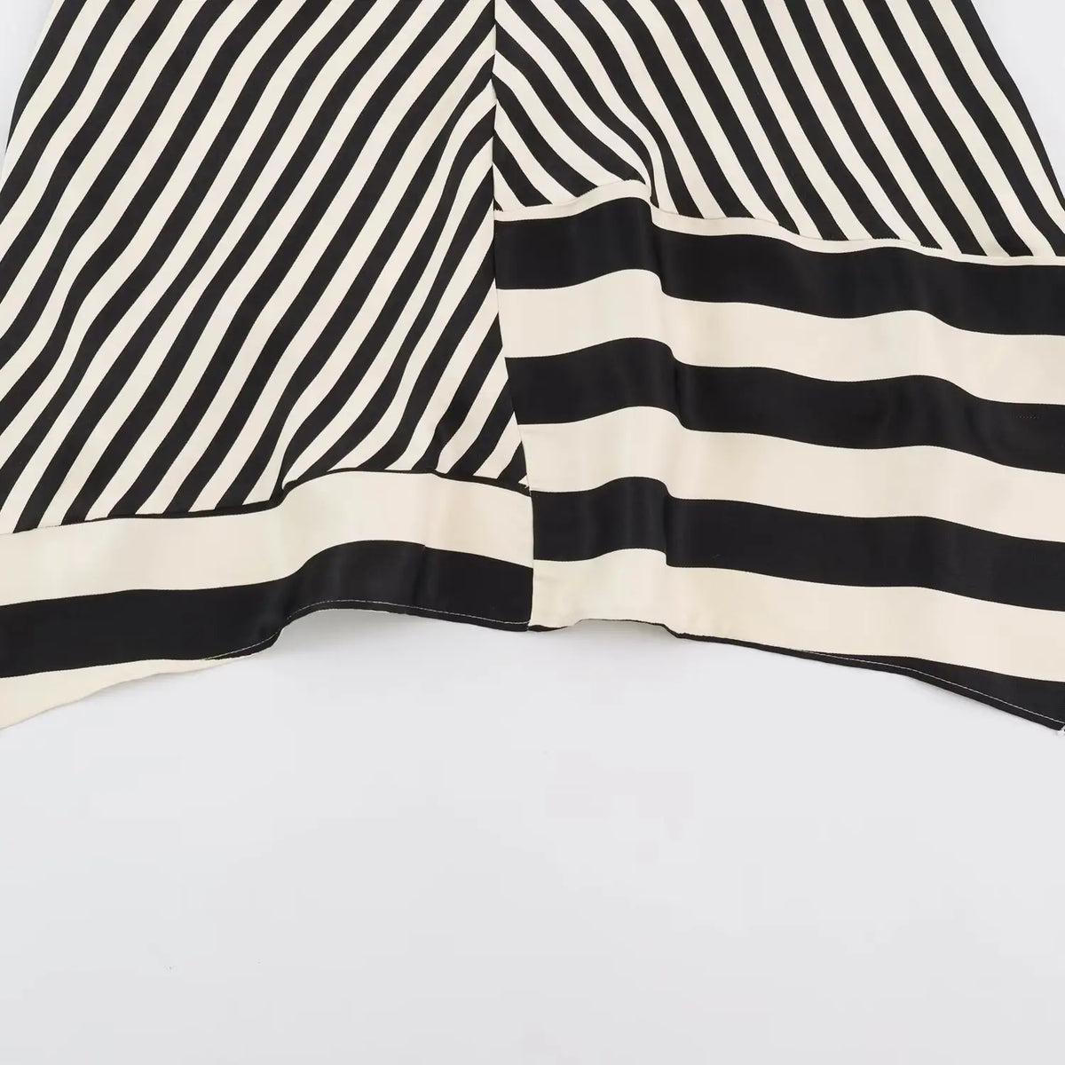 Close-up of asymmetric hem stripe panel